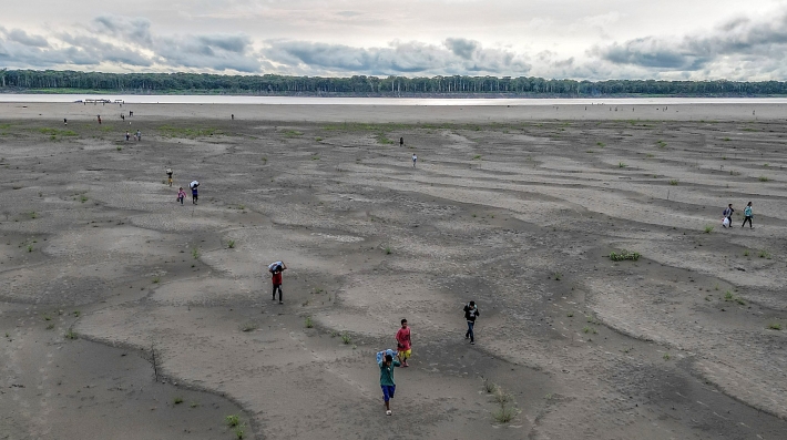 People walking on a dry riverbed