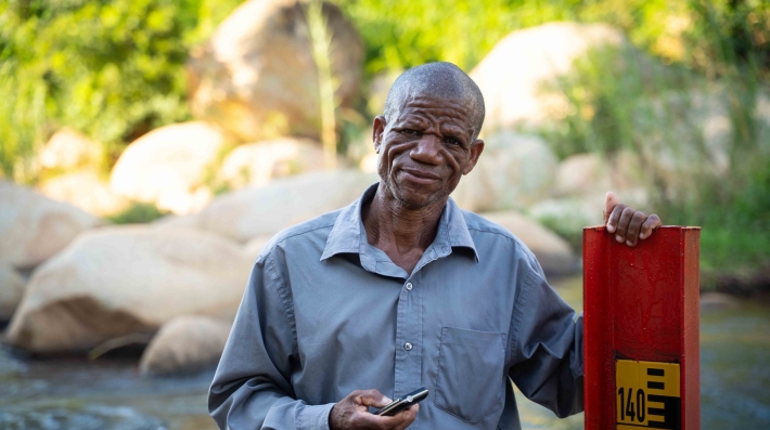 A man next to a water gauge