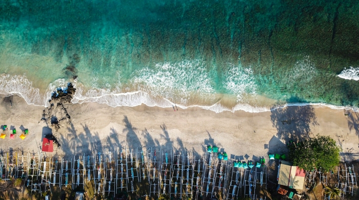 Aerial view of beach, fishing boats and tourists (Bali, Indonesia)