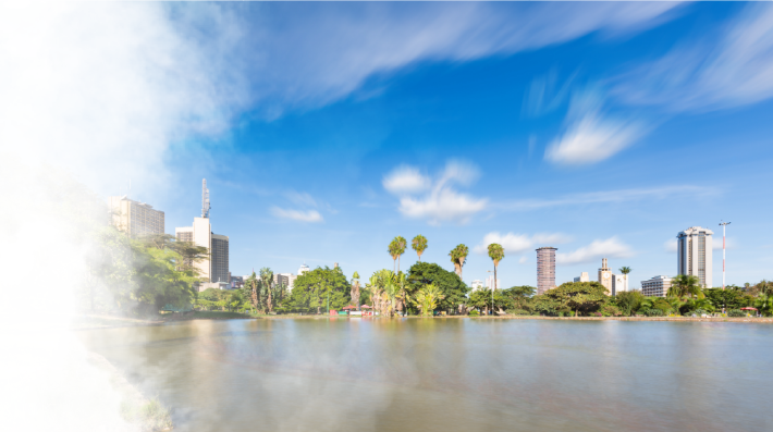 Long exposure of the skyline of Nairobi, Kenya with the beautiful lake in Uhuru Park in the foreground and some blurred boats.