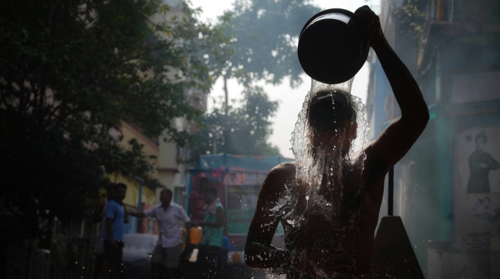 Cooling down with bucket of water in extreme heat