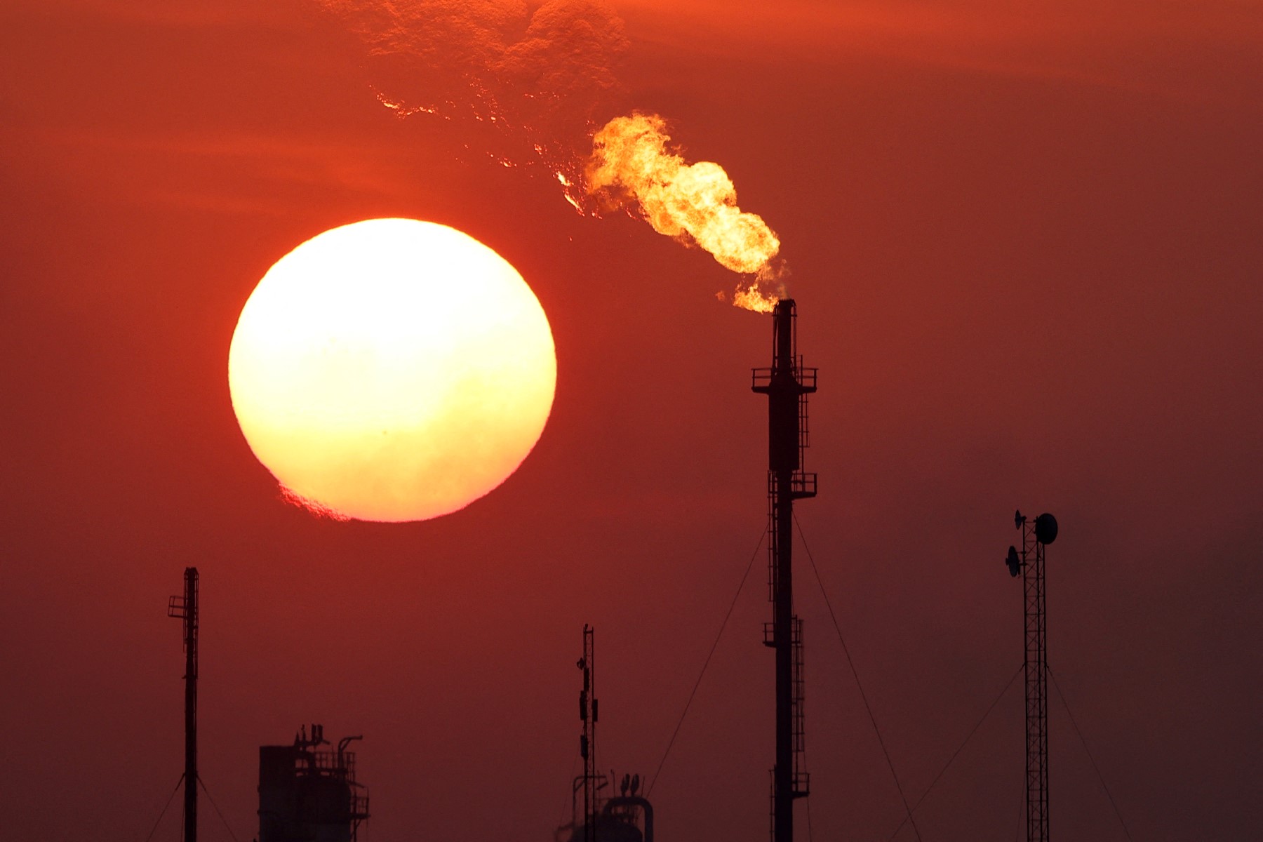 A setting sun and smokestacks