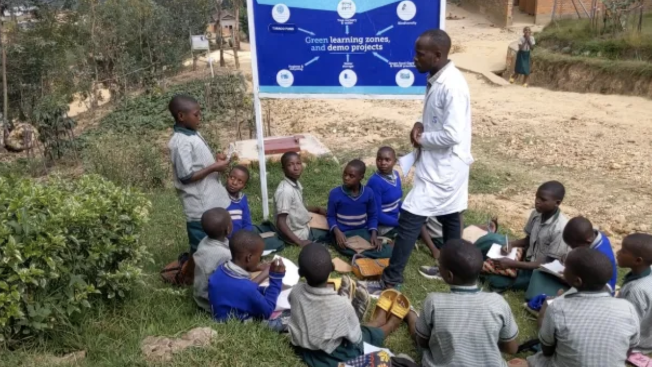 Teacher and children outdoors